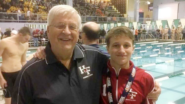 Varsity diving head coach Rick Carlson next to junior Jack Williams after he took home the state title on Feb. 23, 2019. (Provided photo)