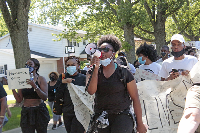 March organizer Tiki Brown leads the crowd in chants expressing anger at the killing of unarmed African Americans by police in a number of incidents nationwide. (Eric Crump/H-F Chronicle)