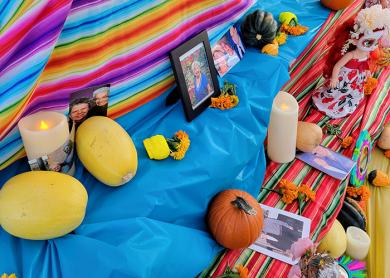 Photos placed on the community ofrenda invite loved ones to return from the land of the dead for one night, according to Mexican tradition. (EC)