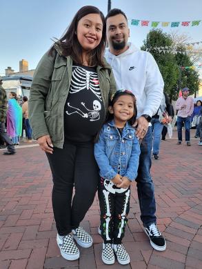 Ivette Nodal wears a whimsical shirt showing a baby skeleton. She was at the festival with her husband, Mario, and daughter, Ady. (EC)