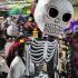 Large papier-mache skeleton figures bob and weave among the dancers during the Homewood Dia de los Muertos festival. (EC)