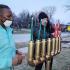 Demarco Jesus Shelton, left, helps Gina LoGalbo place candles in the kinara prior to the Flossmoor Kwanzaa celebration on Sunday. (EC)